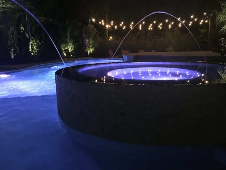 String lights and infinity swimming pool and hot tub Crystal Pools