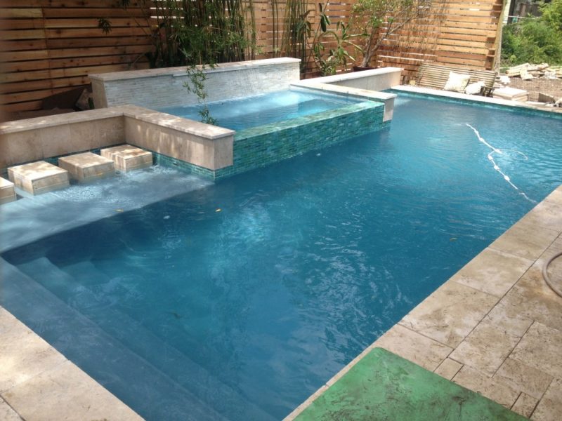 Rain waterfall into a glass tile spa with stepping stones - Crystal ...